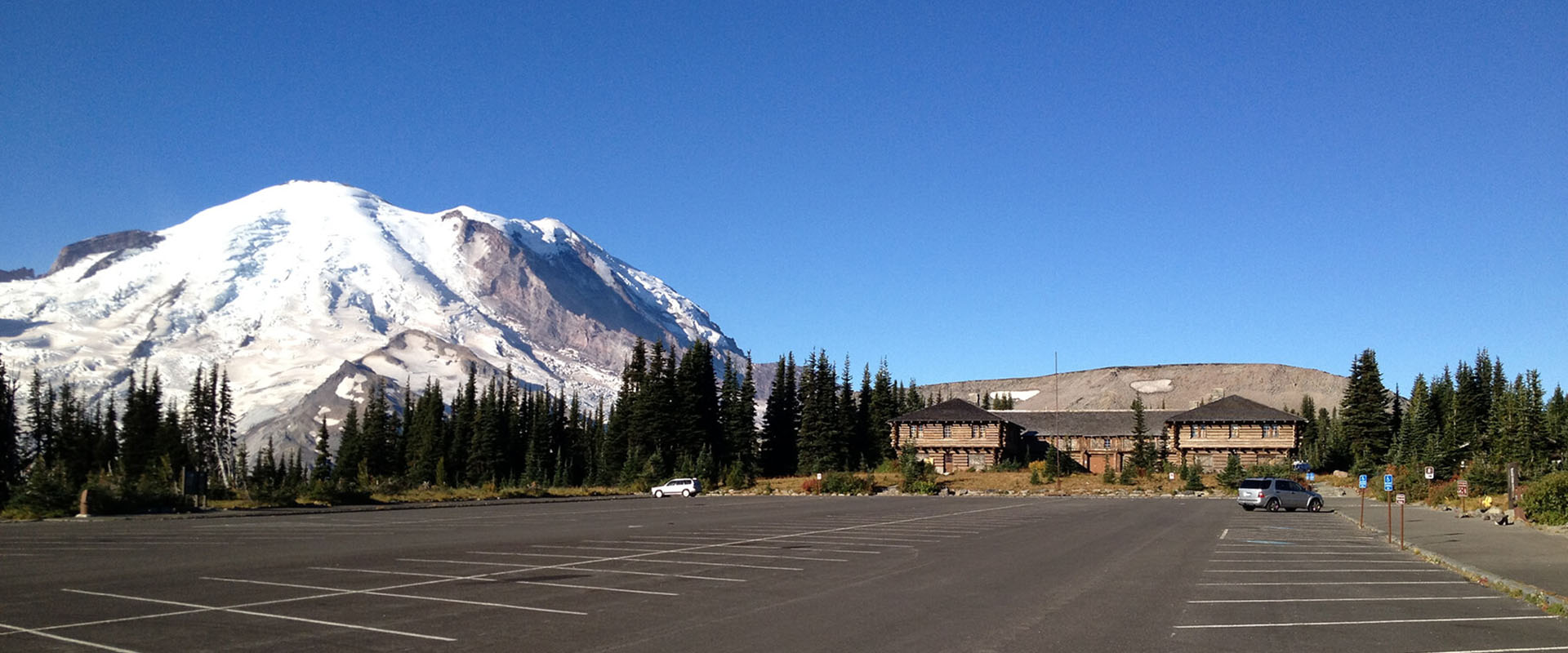 A parking lot with a mountain in the background.