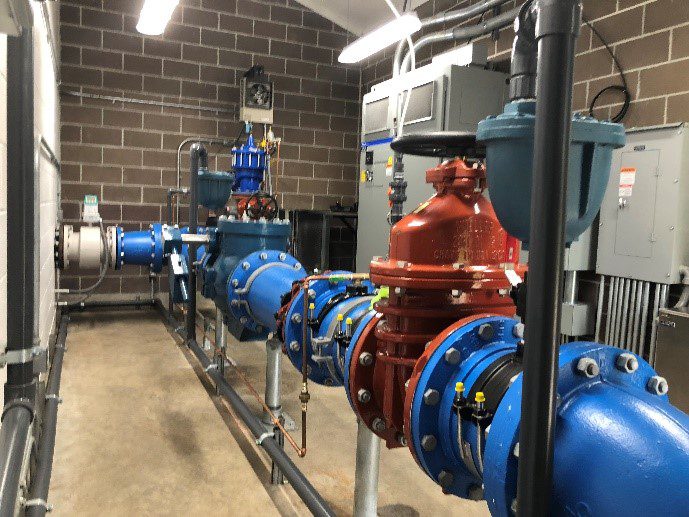 A row of blue and red valves in a building.