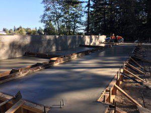 A concrete slab being poured for the driveway.