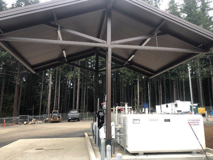 A large metal structure in the middle of a forest.