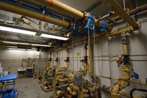 A large room with pipes and valves in it.