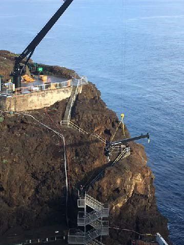 A crane is on top of the cliff.